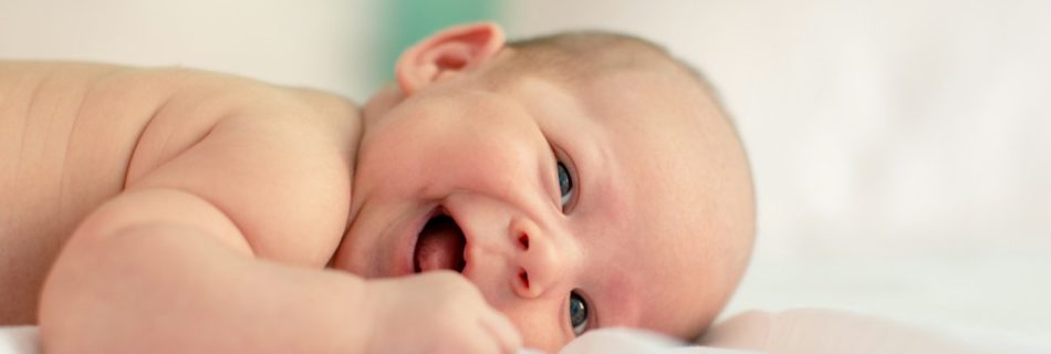 baby lying on fabric cloth